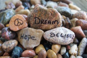 Peace Sign, Dream, Hope, and Believe written on pebbles
