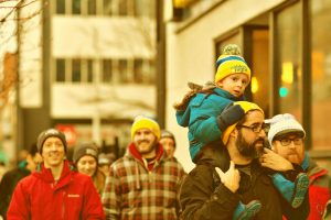 A small boy rides on his father's shoulders during Ray of Hope's Coldest Night of the Year walk