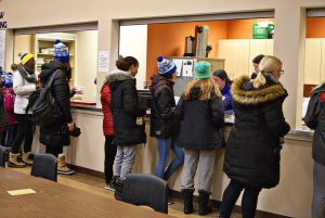 Coldest Night walkers line up for dinner in the Ray of Hope Community Centre