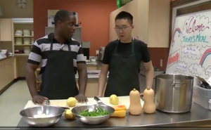 Reporters Start Gooden tallks to Nathan, a Youth Employment Program participant in Ray of Hope's kitchen
