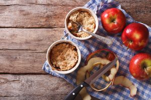 apple crisp with peeled apples on a barnyard background