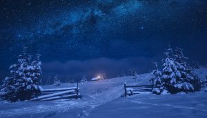 Lonely house on a snowy hill under a starry sky