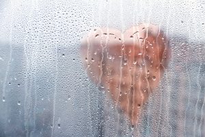 Heart painted on rain-soaked window