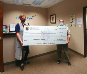Tonya Verburg and Mike Szabo hold a giant cheque