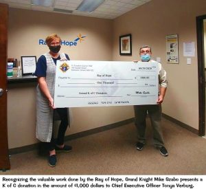 Tonya Verberg and Mike Szabo hold a giant cheque