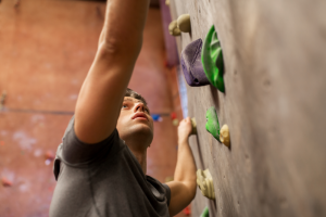Young man climbing on a climbing wall