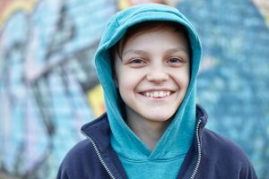 Young smiling boy wearing a hoodie