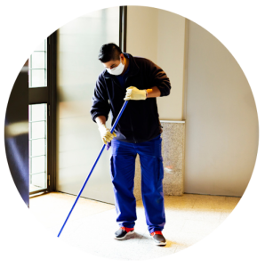 Circle cropped image of man mopping a hallway
