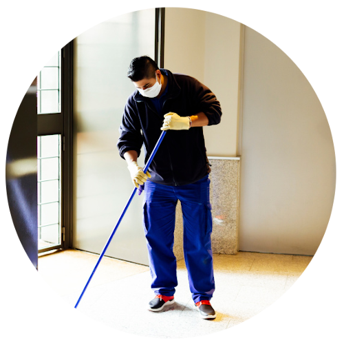Circle cropped image of man mopping a hallway