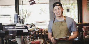 Young Asian man working in an upscale coffee shop